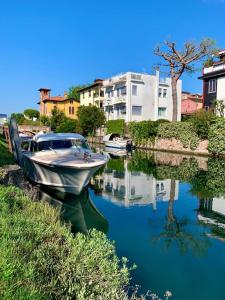 Ein Boot liegt in einem Fluss mit Gebäuden vor Anker. in der Unterkunft Villa Venice Movie in Lido di Venezia