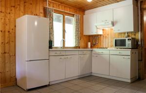 a kitchen with white cabinets and a refrigerator at Beautiful Home In Neede With Wifi in Neede