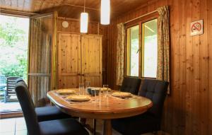 a wooden dining room with a wooden table and chairs at Beautiful Home In Neede With Wifi in Neede