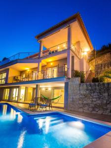 a villa with a swimming pool at night at Villa Tranquila in Jávea