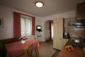 a small kitchen with a table and a kitchen at Haus Ebner in Sankt Gilgen