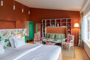a bedroom with a bed and a table and chairs at Vår Gård Saltsjöbaden in Saltsjöbaden