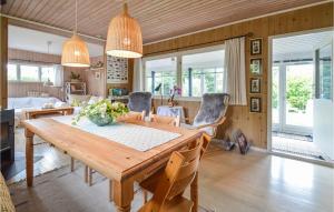 a dining room with a wooden table and chairs at Amazing Home In Stubbekbing With Kitchen in Stubbekøbing