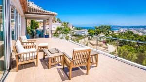 a patio with chairs and a table on a balcony at Villa Tranquila in Jávea