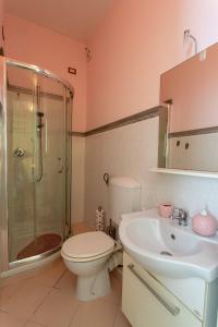 a bathroom with a toilet and a shower and a sink at B&B Milù in Civitanova Marche