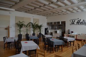 comedor con mesas y sillas y cocina en U Heligonky, en Brno