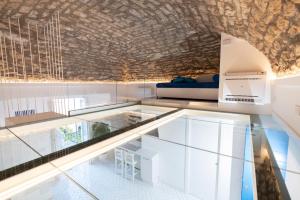 a glass floor in a room with a bed at Lampara in Vico Equense