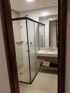 a bathroom with a glass shower and a sink at Alta Vista Thermas Resort in Caldas Novas