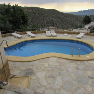 a large swimming pool with a view of a mountain at ALBARICO RETREAT in Bédar