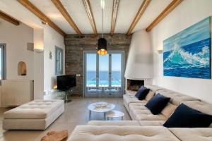 a living room with a couch and a table at Villa Sandra Maria in Vourkari