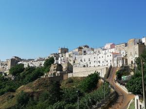 a group of white buildings on top of a hill at Milleunastella in Montescaglioso