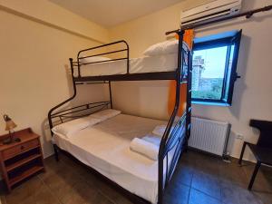 a bedroom with two bunk beds and a window at Frigano 3 in Stoupa