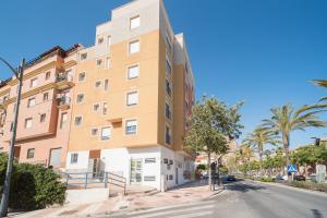 a large building with a clock on the side of it at Apartamentos Puerto Aguadulce in Aguadulce