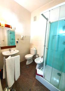 a bathroom with a toilet, sink, and shower at Residencia LIS B&B in Porto