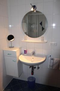 a bathroom with a sink and a mirror at Haus Pirchl in Westendorf +10 photos