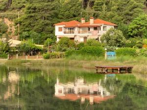 une maison assise sur le côté d'un lac dans l'établissement DREAM VIEW LIVARI, à Vourvourou