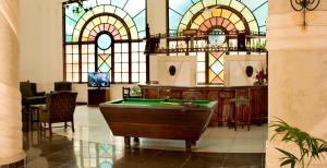 a pool table in a room with stained glass at Neptune Beach Resort - All Inclusive in Bamburi