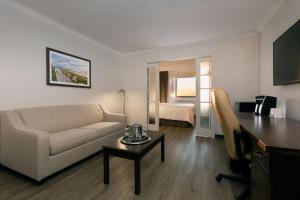 a living room with a couch and a table at Hotel Rimouski in Rimouski