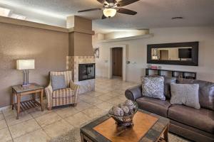 a living room with a couch and a fireplace at Lake Havasu Home with Heated Pool, Spa and Mtn Views! in Lake Havasu City