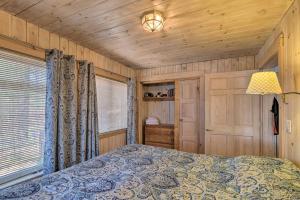 a bedroom with a bed and a lamp in a room at Quiet Waterfront Cabin with Dock, Game Room, Hot Tub in Greenwood