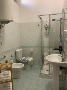a bathroom with a toilet a sink and a shower at Duplex Catania Airport in Catania