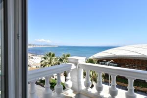 a balcony with a view of the beach and the ocean at Iliad Hotel in Durrës