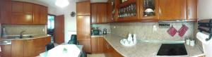 a kitchen with wooden cabinets and a counter top at House Fox in Iraklitsa