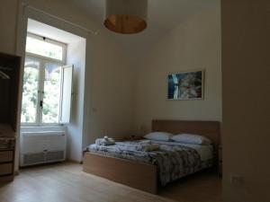 a bedroom with a bed with two teddy bears on it at i due fratelli casa vacanza in Vietri sul Mare