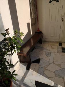 
a wooden bench sitting in front of a door at Meje Apartments in Split
