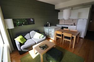 a living room with a couch and a table at Apartment Ylläs Ski Chalets 7202, Incl 2 lift tickets in winter season in Ylläsjärvi