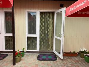an open door of a house with potted plants at Номера в Фонтанке in Fontanka