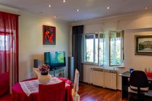 a living room with a table and a television at Apartment Gea in Ičići