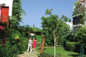 a man and woman standing in a garden at DELTA SHARM RESORT ,Official Web, DELTA RENT, Sharm El Sheikh, South Sinai, Egypt in Sharm El Sheikh