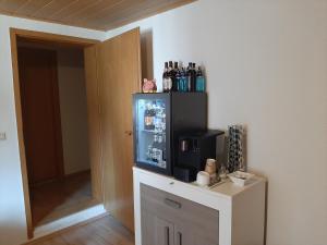 a room with a refrigerator with drinks in it at Gästehaus Pension Waldhorn in Weilen unter den Rinnen