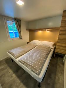 a small bed in a room with a window at SUNNY Mobile Homes Bijela Uvala in Poreč +52 photos