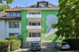 a building with a mural of a woman on it at Boutique Apartments am Stadtgarten in Freiburg im Breisgau