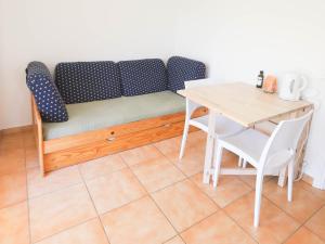 a couch in a room with a table and a table and chair at Orangeraie du Cap d'Antibes in Antibes
