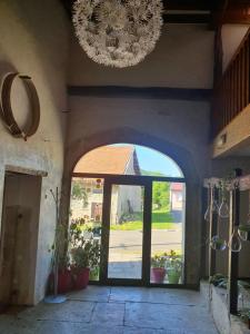 an entrance to a building with a chandelier at La Bergerie Crenantine in Crenans