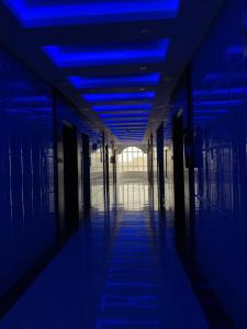 a hallway with blue lights in an office building at Alshahamah Hotel Apartments in Najran