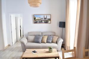 ein Wohnzimmer mit einem Sofa und einem Couchtisch in der Unterkunft Apartamento La Discusión de Veedor 12 in Cádiz