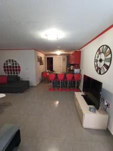 a living room with a couch and a clock on the wall at casa al mare in Kavála