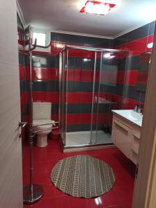 a red and black bathroom with a toilet and a shower at casa al mare in Kavála +17 photos