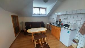 Vitosha Guest House في ديفين: مطبخ صغير مع طاولة وميكروويف