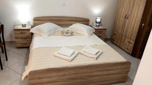 a bedroom with a large bed with two towels on it at Nikko's apartments Elafonisos in Elafonisos