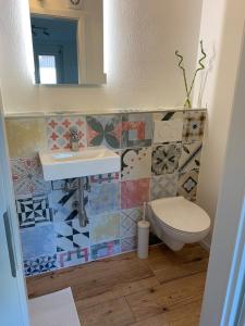 a bathroom with a sink and a toilet at Greenhome in Weil am Rhein