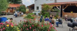 a group of people sitting in a garden at Iowa Room in Memmingen