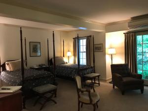 a bedroom with two beds and a desk and a chair at The Old Lyme Inn in Old Lyme
