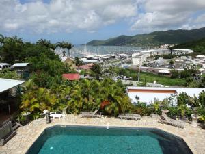 a swimming pool with a view of a resort at Résidence des îles in Le Marin