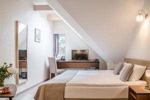 Postel nebo postele na pokoji v ubytování Grottger Luxury Boutique Hotel City + 37 fotografií