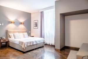 Postel nebo postele na pokoji v ubytování Grottger Luxury Boutique Hotel City